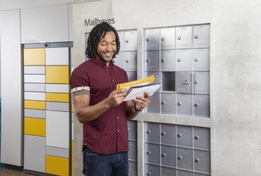 Man at mailbox looking at mail