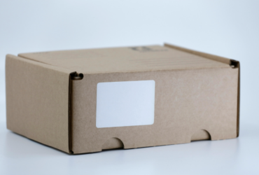 A cardboard shipping container with a blank label