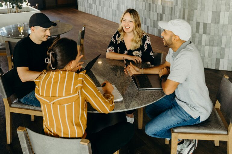 A group of four people sitting at a table
