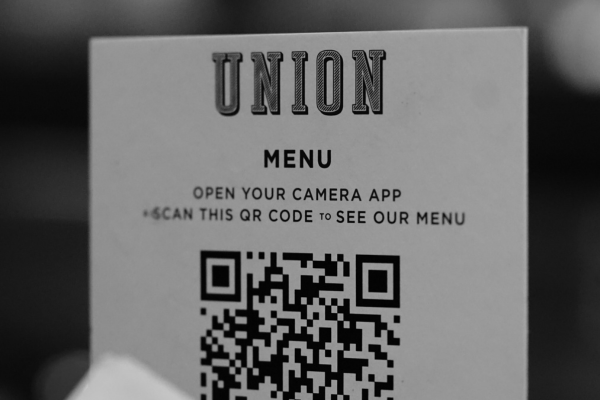 A paper menu with a QR code printed on it