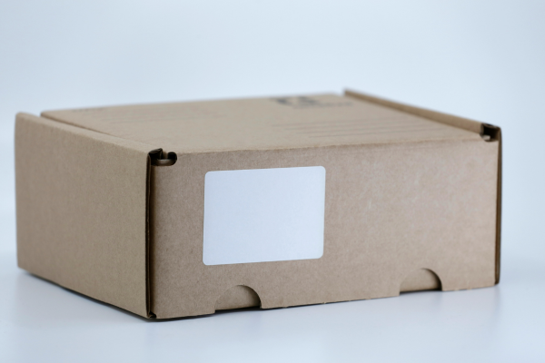 A cardboard shipping container with a blank label
