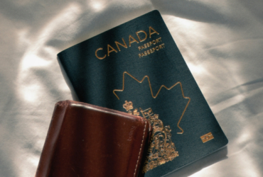 A Canadian passport next to a wallet