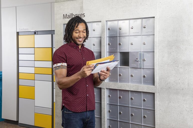Man at mailbox looking at mail