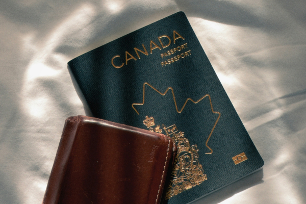 A Canadian passport next to a wallet