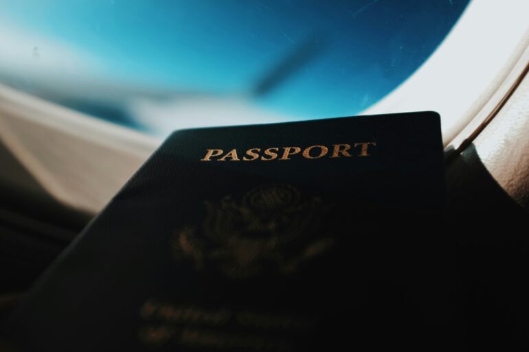 A passport in front of a plane window