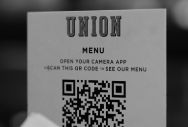 A paper menu with a QR code printed on it