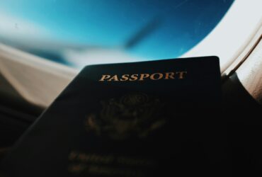 A passport in front of a plane window