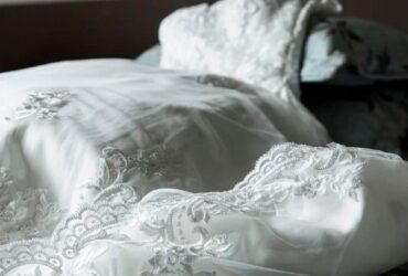 a white wedding dress with lace