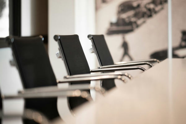 Professional chairs at a long table in an office