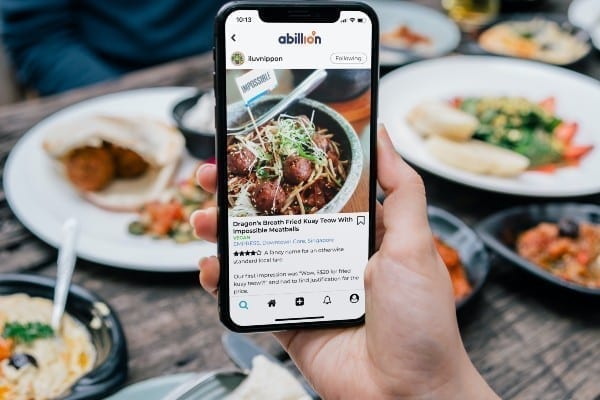 a photo of a phone taking photos of food in a restaurant