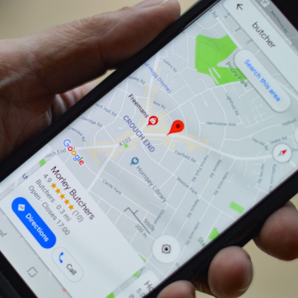 a person holding up a phone with a Google Business Profile on the screen