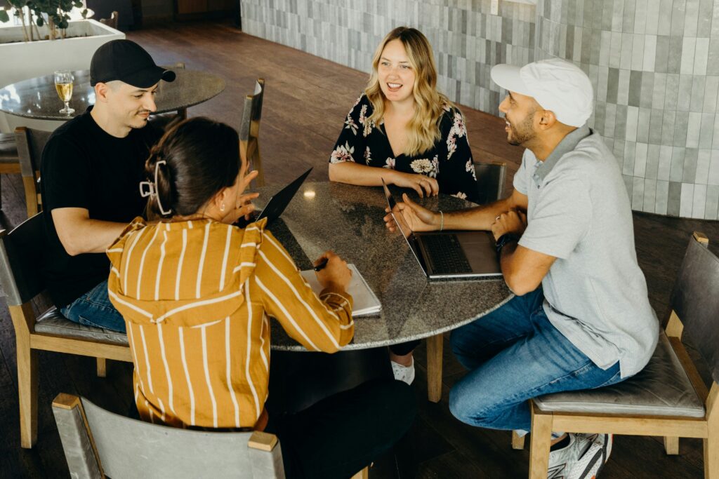 A group of four people sitting at a table